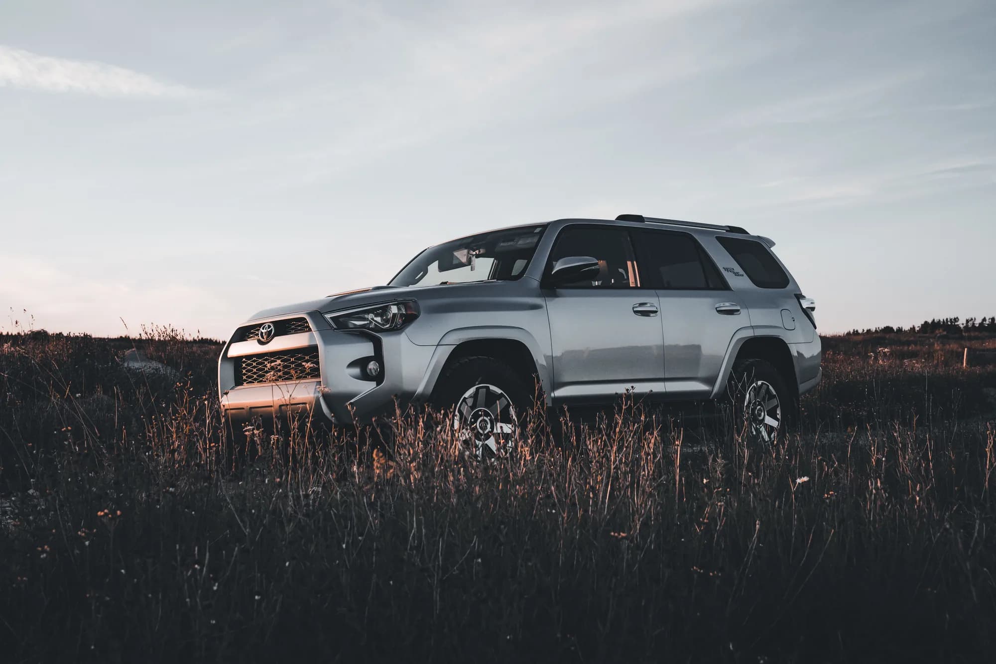 Silver Toyota 4Runner representative vehicle image in a field